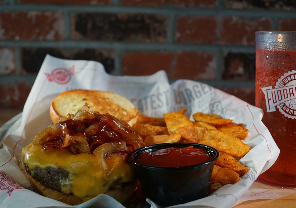 Bbq Burger · 100% all-American premium cut 1/2 pound beef burger. Topped with grilled onions, cheddar cheese, smokehouse bacon, and smokehouse sauce. (item includes lettuce, tomato, and onion on the side.)