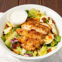 Grilled Chicken Salad · Grilled chicken, Monterey Jack, and cheddar cheese, smokehouse bacon, tomatoes, croutons, eg...