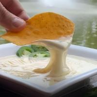 Queso Dip · A melted cheese dip. Add chorizo for an additional charge.