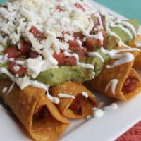 Taquitos · Fried corn tortillas stuffed with chicken. Topped with sour cream, fresh lime pico de gallo,...