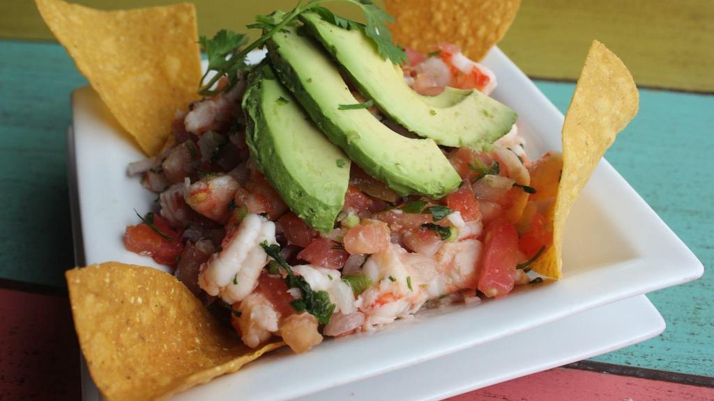 Shrimp Ceviche · Fresh shrimp marinated in lime juice, mixed with onions, tomatoes, cilantro, fresh jalapeño, and slices of avocado.