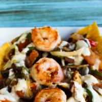 Fajita Nachos · Chicken breast, shrimp, and steak grilled with onions, peppers, and tomatoes. Topped with qu...