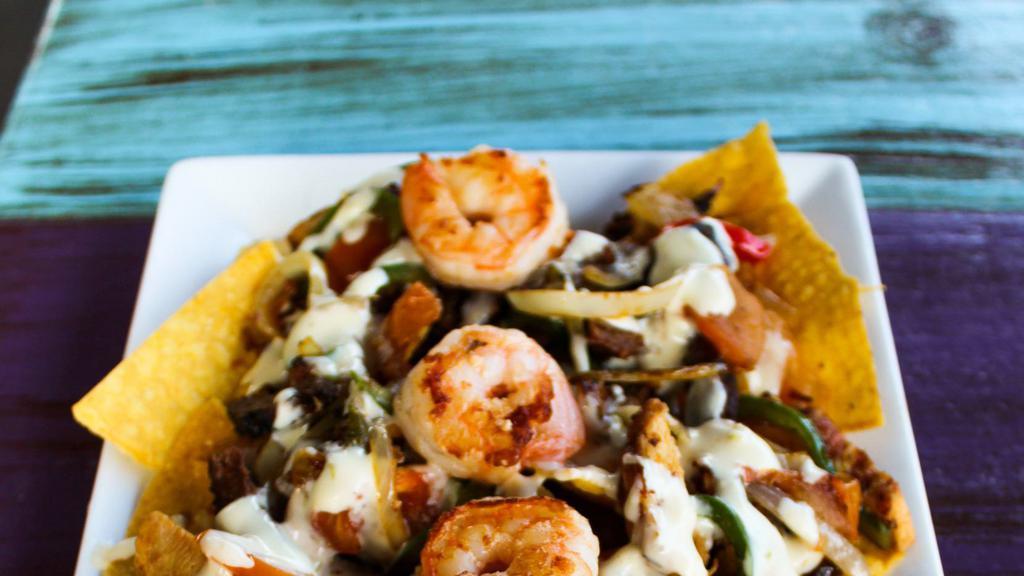 Fajita Nachos · Chicken breast, shrimp, and steak grilled with onions, peppers, and tomatoes. Topped with queso dip.