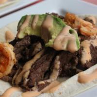 Surf & Turf · Skirt steak and shrimp topped with avocado and sriracha ranch. Served in a flour tortilla.