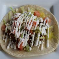 The Americana · Ground beef or shredded chicken topped with lettuce, queso fresco, tomatoes, and sour cream....