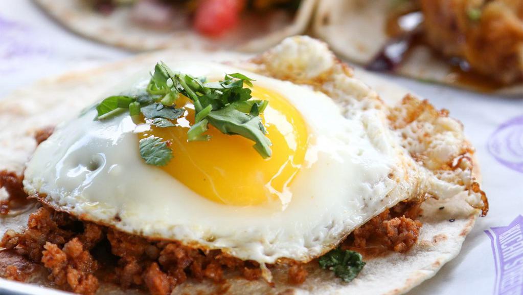 Sunny-Side Up · Chorizo, sunny-side egg, and cilantro. Served in a flour tortilla.