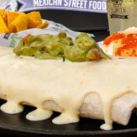 Fajita Burrito · Steak, shrimp, chicken, peppers, onions, tomatoes, rice, and sour cream. Topped with queso d...