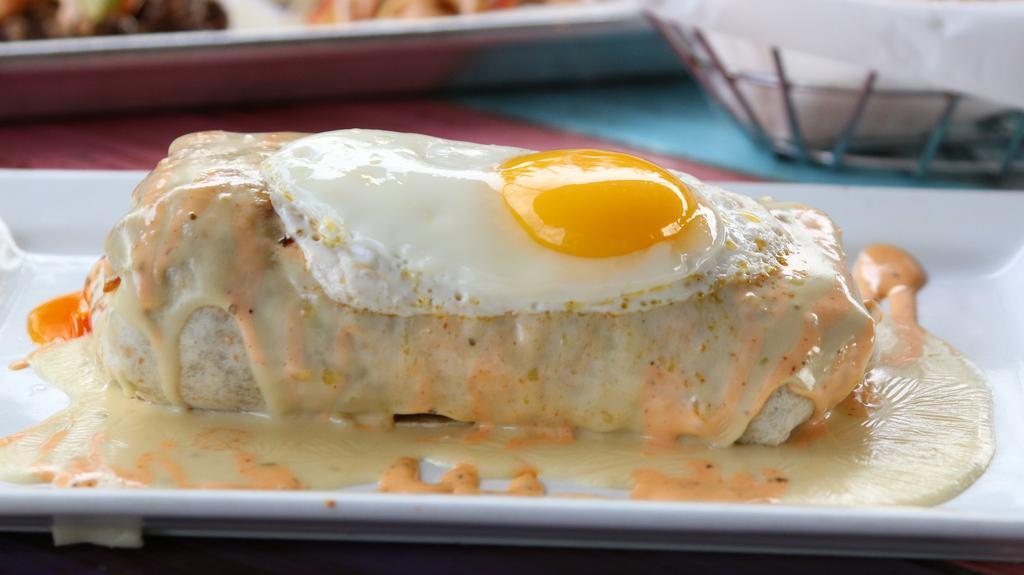 Sunrise Burrito · Chorizo, eggs, French fries, and guacamole. Topped with queso dip, sunny-side egg, and sriracha ranch.