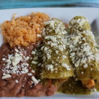 Enchiladas Suizas · Corn tortillas stuffed with grilled chicken and topped with green tomatillo sauce and queso ...