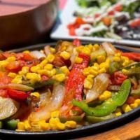 Veggie Fajitas · Red and green bell peppers, onions, tomatoes, zucchini, and corn. Served with a side of whit...
