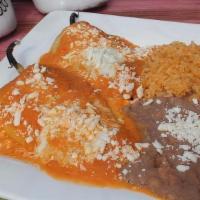 Chile Relleno · 2 Poblano peppers battered in egg and stuffed with shredded cheese. Topped with our signatur...