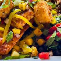 Blackened Mahi · Lightly breaded and grilled mahi filets served with white rice vegetable medley and black be...
