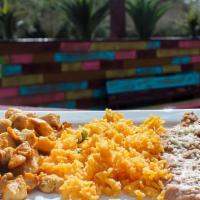 Kids' Grilled Chicken · Grilled chicken with side of rice and beans.