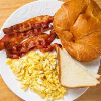 Scrambled Eggs · Three Freshly cracked Scrambled eggs with choice of meat and bread.