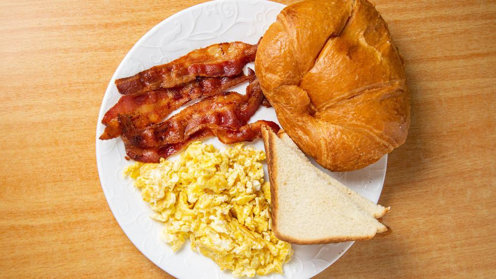 Scrambled Eggs · Three Freshly cracked Scrambled eggs with choice of meat and bread.