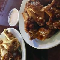 Wings · Lip-smackin' wings soaked in your favorite sauce served with celery sticks and choice of hou...