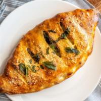 Cheese Calzone · Mozzarella, parmesan, and ricotta cheese baked inside a pizza crust.
