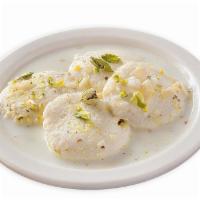 Ras Malai (4 Pieces) · Small balls of curd cheese (Paneer) served in a cold thick and sweetened milk sauce.