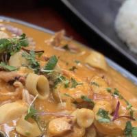 Pescado A Lo Macho · Fried fish topped with macho seafood sauce served with rice.