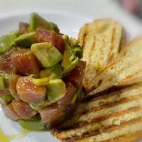 Tuna Tartar · Avocado, tropical glaze & fresh lime juice, served with crostini bread.