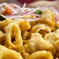 Calamares Fritos · Calamari rings battered and flash fried. Served with salsa criolla and fried yucca.