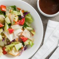 House Salad · Iceberg, romaine lettuce, tomatoes, cucumbers, onions, and carrots.