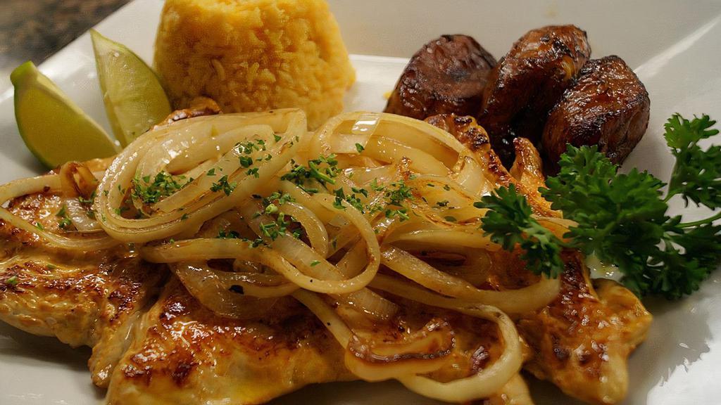 Pechuga De Pollo A La Plancha · Chicken breast marinated with citrus juice, garlic mojo, and topped with grilled onions.
Served with rice, black beans and plantains.
