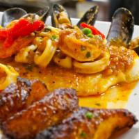 Filete De Pescado A Lo Macho · Golden sea bass fillet grilled, topped with shrimp, calamari, octopus, and mussels in a deli...