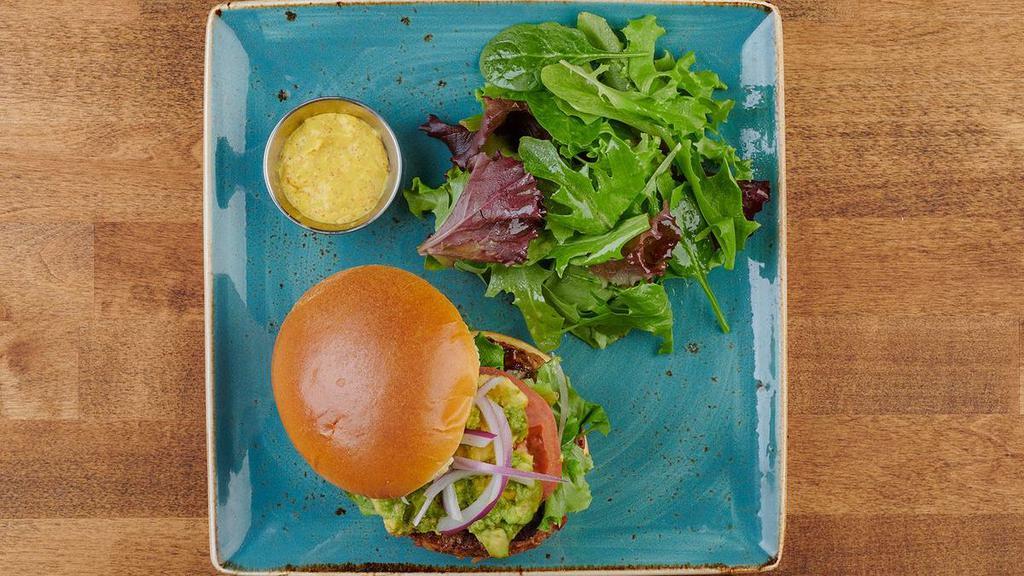 Veggie Burger · A seasoned all-natural patty of brown rice, Peppadew peppers, onions, carrots and mushrooms. Served on a brioche bun with fresh smashed avocado, organic mixed greens, tomato, red onion and a side of Dijonnaise. Served with lemon-dressed organic mixed greens or a bowl of tomato basil soup.