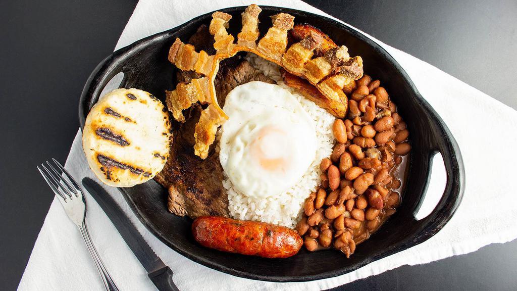 Bandeja Paisa · Rice, beans, steak, sausage, fried pork, egg, plantain, arepa.
