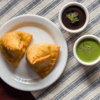 Samosa 2 Pcs · Two pieces. Samosa is deep fried pastry with a spiced filling usually made with potatoes, sp...