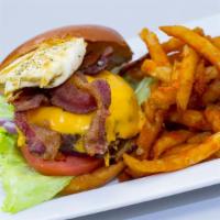 Brunch Burger · With bacon, and one egg, garnished with a Romaine lettuce cup, sliced tomato, red onions.