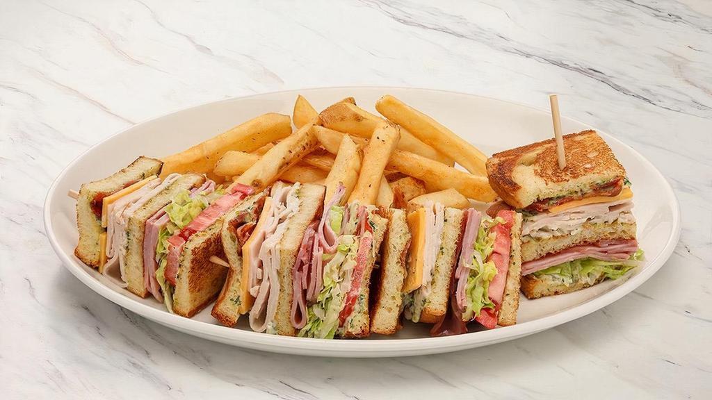 Classic Club Sandwich · Sourdough bread, roasted red pepper mayo, Sharp cheddar, applewood-smoked bacon, lettuce, tomato