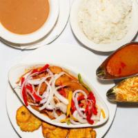 Lambi /Conch · Served in creole sauce with salad, rice & plantains