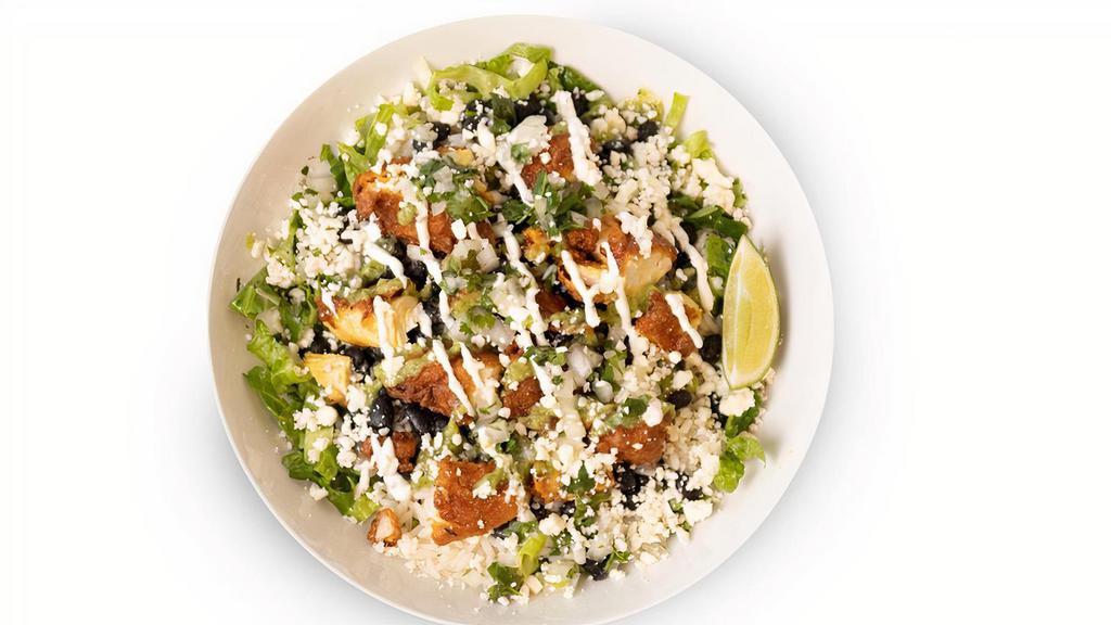 Barbacoa Bowl · Shredded lettuce, white rice, black beans, cilantro lime creme fraiche, guasacaca, cilantro onion salsa, queso fresco, and squeeze of fresh lime juice with your choice of topping.