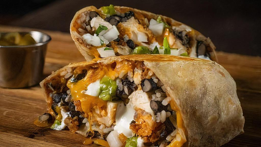 Smokehouse Burrito · Flour tortilla, refried beans, white rice, black beans,  guasacaca, yum yum sauce, shredded cheddar cheese, cilantro onion salsa with your choice of meat.