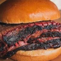 Signature Angus Brisket Sandwich · 30 day wet-aged beef brisket, rubbed with our 4R Brisket Rub and smoked for 18 hours. Hand s...