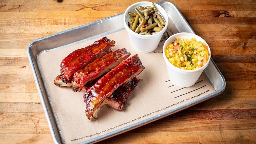 1/2 Rack Of St. Louis Style Ribs + 2 Sides · Seasoned with 4R All Purpose Rub,  smoked and finished with a Honey BBQ sauce. Comes with 2 sides.