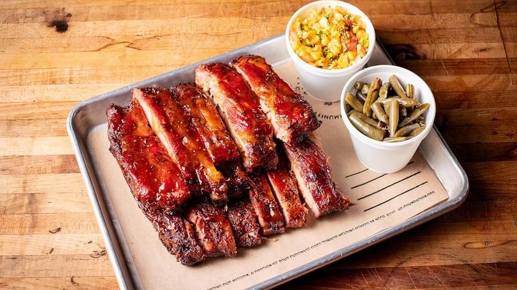 Full Rack Of St. Louis Style Ribs + 2 Sides · Seasoned with 4R All Purpose Rub, smoked and finished with a Honey BBQ sauce. Comes with 2 sides.
