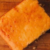 Texas Cornbread · Traditional cornbread baked with jalapenos and cheddar cheese until golden brown and brushed...