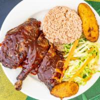 Jerk Chicken (Dark) · Served with either rice and peas or white rice and steamed vegetables and two plantains.