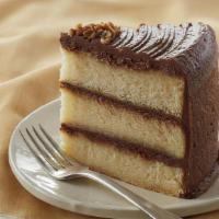 Yellow Chocolate Slice · Same fudge frosting as our chocolate cake, but with our fluffy and delicate yellow cake on t...