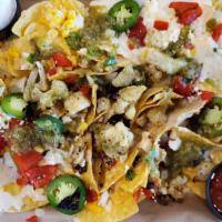 Chicken Nachos · Sliced chicken, queso, cheddar jack and cotija cheeses, fire roasted red peppers, onion and ...