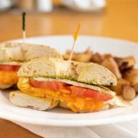 Cheesy Egg Sandwich · Two fried eggs, bacon, tomato, cheddar, pesto sauce, and bacon on a toasted bagel. Seasoned ...
