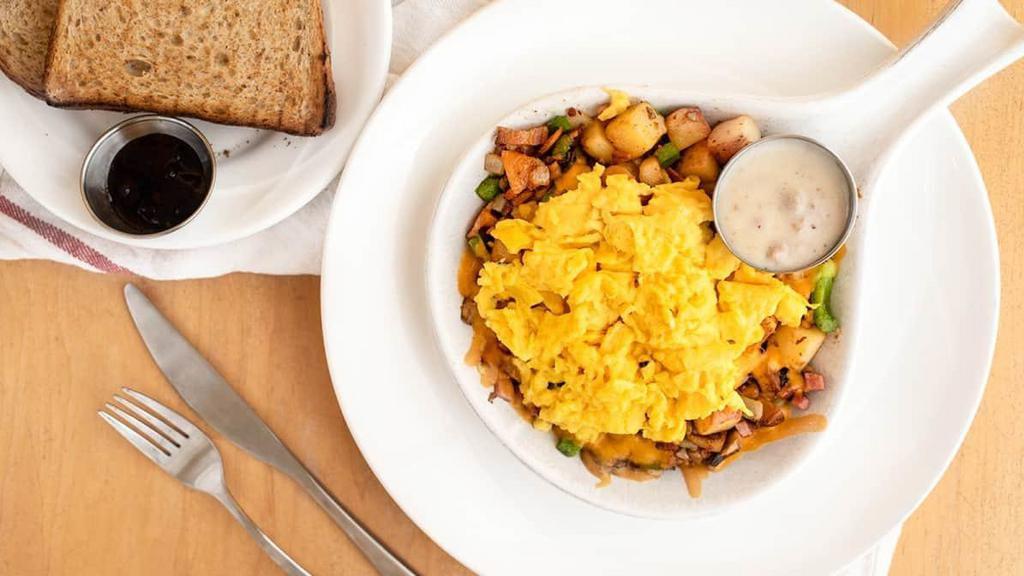 Countryside Skillet · Seasoned potatoes, bacon, ham, sausage, mushroom, onion, green pepper, Cheddar. Two eggs any style. Side of country sausage gravy. Toast, pancakes, or English muffin.