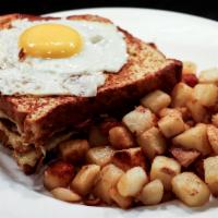 Croque Madame · Grilled Ham, turkey, Swiss and dijon sauce layered within slices of challah French toast, to...