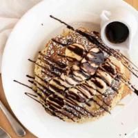 Nutty Monkey Cakes · Pancakes filled with banana slices and chocolate chips, layered with peanut butter. Topped w...