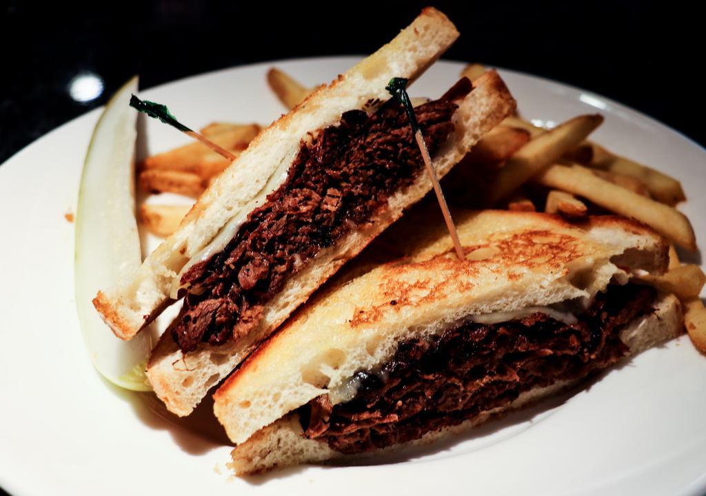 Pot Roast Sandwich · Staff faves. Slow-roasted tender pot roast in natural au jus, topped with melted swiss cheese. Grilled sourdough bread.