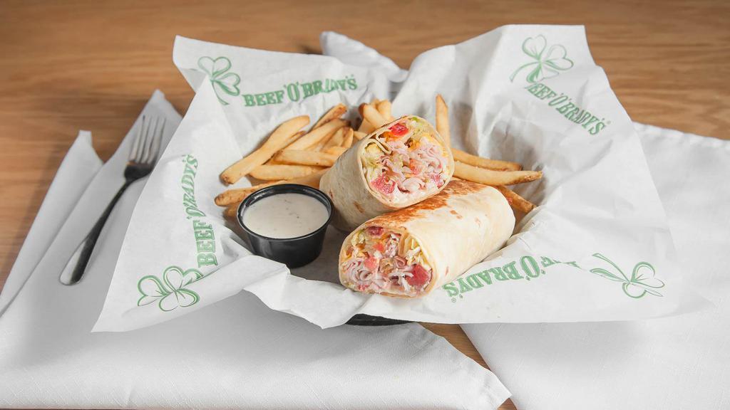 Club Wrap · Thinly sliced ham and turkey with smoked bacon, cheddar jack cheese, lettuce, tomatoes and mayo, pressed in a flour tortilla. Served with a side of ranch dressing. (1360 Cal)