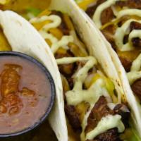 2 Steak Tacos · Grilled Angus skirt steak topped with lettuce, cheddar jack cheese and creamy Poblano sauce....